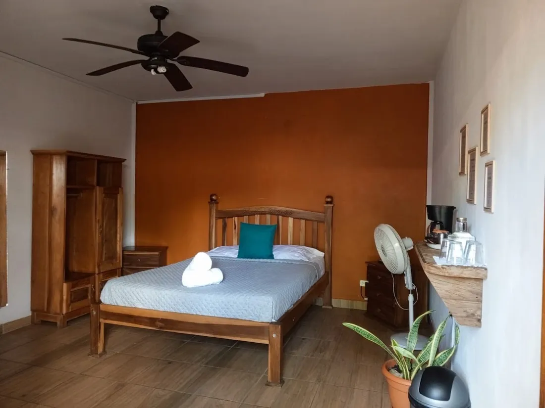 Room Two — queen bed against a warm terracotta wall