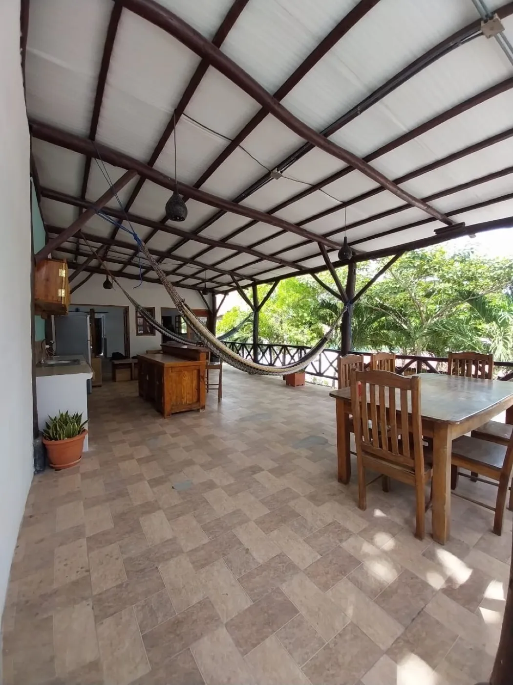The Grand Suite's private upper terrace — outdoor dining, hammock and ocean view